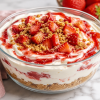 No-Bake Strawberry Cheesecake Bowl topped with fresh strawberries, strawberry sauce, and graham cracker crumbs.